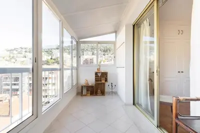 a large room with large windows and white floors at Eat - Sleep - Wander Chic and Cosy Flat in Nice
