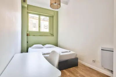 a room with two beds and a window at Magnificent apartment - Carré d'or in Nice