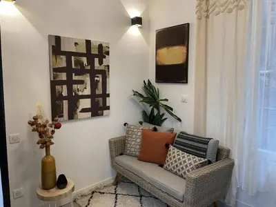 a living room with a couch with pillows on it at Apart Nissa Bella Massena / Vieux Nice in Nice