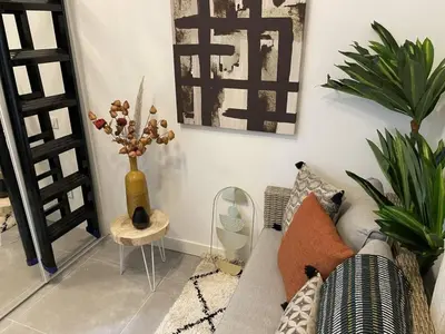 a living room with a couch and a table with plants at Apart Nissa Bella Massena / Vieux Nice in Nice