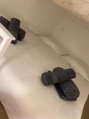 a bed with two towels on top of it at Apart Nissa Bella Massena / Vieux Nice in Nice