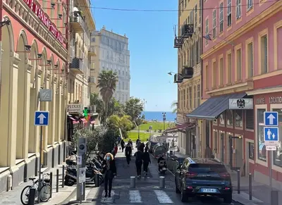 a city street with buildings and people walking down the street at OPERA PROMENADE 2 Renovated 1 min to Beach Air Conditioning in Nice