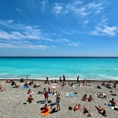 a group of people laying on a beach at OPERA PROMENADE 2 Renovated 1 min to Beach Air Conditioning in Nice