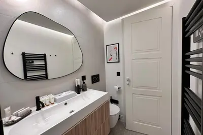 a bathroom with a white sink and a mirror at OPERA PROMENADE 2 Renovated 1 min to Beach Air Conditioning in Nice
