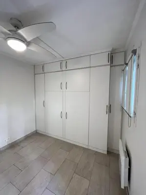 an empty room with white cabinets and a ceiling fan at Casa Alessia - Villefranche-sur-mer in Villefranche-sur-Mer