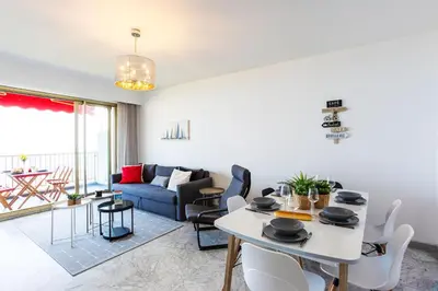 a living room with a table and chairs and a couch at LE SIRIUS AP4314 By Riviera Holiday Homes in Nice