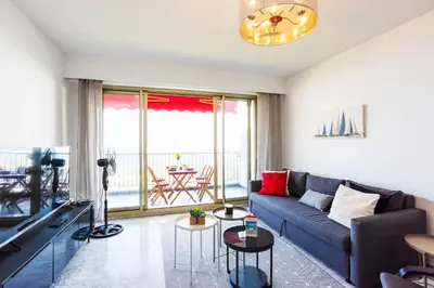a living room with a couch and a table at LE SIRIUS AP4314 By Riviera Holiday Homes in Nice