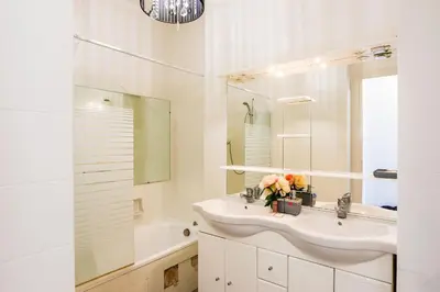 a white bathroom with a sink and a tub at LE SIRIUS AP4314 By Riviera Holiday Homes in Nice