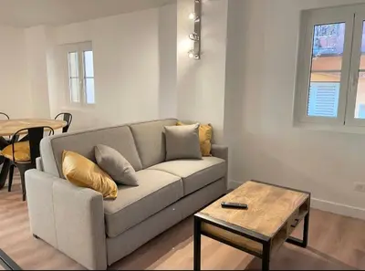 a living room with a couch and a table at Homelivia,Industriel cosy in Nice