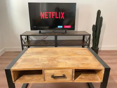 a tv sitting on top of a coffee table at Homelivia,Industriel cosy in Nice