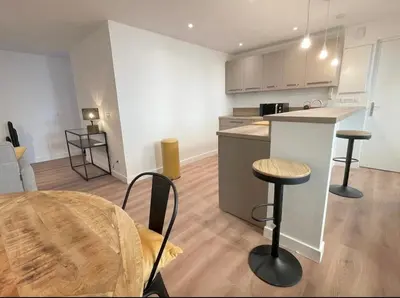 a kitchen and a living room with a table and chairs at Homelivia,Industriel cosy in Nice