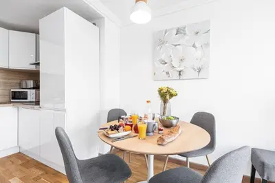 a dining room with a wooden table and chairs at MY CASA - JOFFRE 2 - Cosy apartment in City Center in Nice