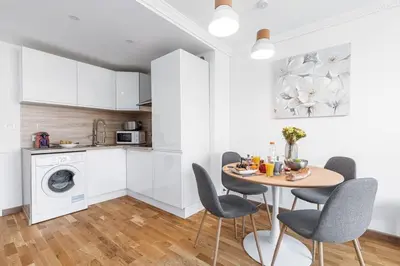 a kitchen and dining room with a table and chairs at MY CASA - JOFFRE 2 - Cosy apartment in City Center in Nice