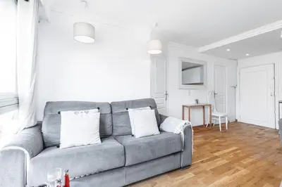 a living room with a gray couch and a table at MY CASA - JOFFRE 2 - Cosy apartment in City Center in Nice