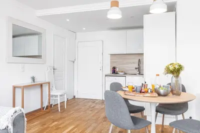 a kitchen and dining room with a table and chairs at MY CASA - JOFFRE 2 - Cosy apartment in City Center in Nice