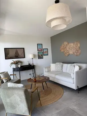 a living room with a couch and a table at Appartement de luxe Eze village vue mer avec piscine in Èze