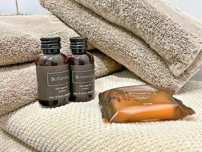 two bottles of honey and a bag of caramel on a towel at Homelivia, VIEUX NICE, appartement de charme, clim balcon in Nice