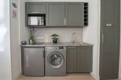 a kitchen with a washing machine and a sink at Studio Famous bd Victor Hugo - city center in Nice