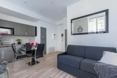 a living room with a couch and a table at Studio Famous bd Victor Hugo - city center in Nice