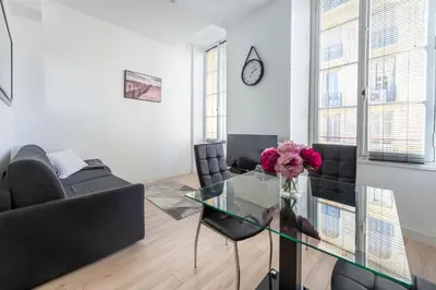 a living room with a glass table and a couch at Studio Famous bd Victor Hugo - city center in Nice