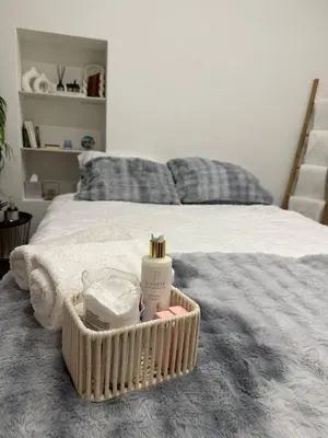 a basket of soap and other items on a bed at Cosy studio VIEUX NICE à 2 pas de la MER in Nice
