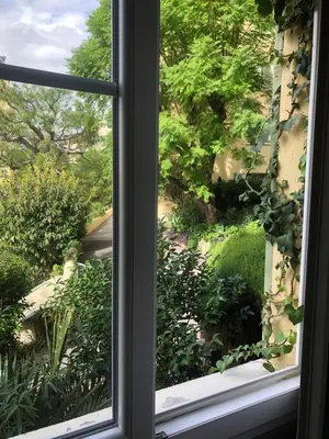 a window with a view of a garden at Charmante chambre privée 5/10 mn du CentreVille/Port-Jardin/Parking in Nice
