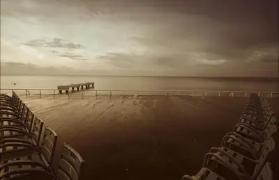 a group of chairs on a beach with the ocean at La plume de Paul in Nice