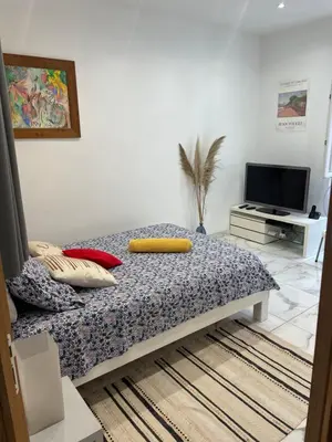 a bedroom with a bed and a tv in it at Nice Libération in Nice