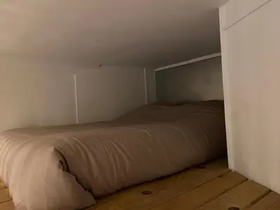 a bed in a small room with a wooden floor at Rentomatique Studio Jean Médecin in Nice