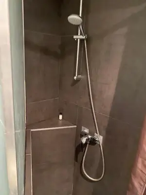 a shower with a shower head in a bathroom at Rentomatique Studio Jean Médecin in Nice