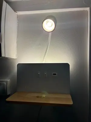 a light in a room with a wooden table at Rentomatique Studio Jean Médecin in Nice