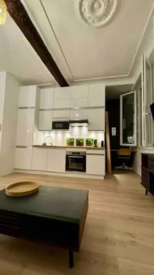 a large kitchen with a table in a living room at 06R - Nice modern apartment - Vieux Nice in Nice