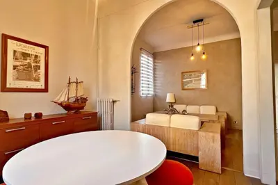 a bedroom with a bed and a white table at Au Petit Bourgeois in Nice
