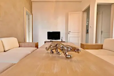 a statue of a lion on a table in a living room at Au Petit Bourgeois in Nice