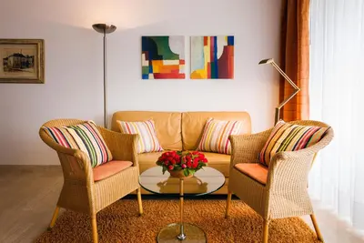 a living room with a couch and two chairs at Ferienwohnung Les Oliviers über den Dächern von Nizza ruhig sonnig Meerblick Pool Tiefgarage Parkplatz in Nice