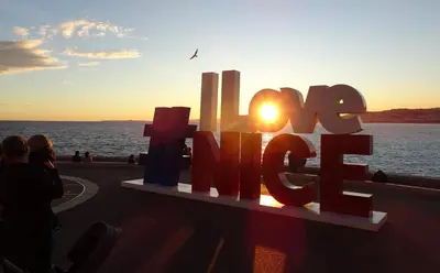 a sign that says h love with the sunset in the background at 