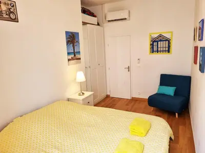 a bedroom with a bed and a blue chair at 