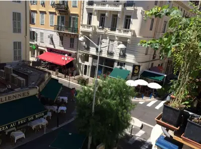 an overhead view of a city street with tables and umbrellas at Royal apartment near the beaches in Nice