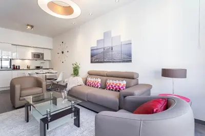 a living room with a couch and a table at Royal apartment near the beaches in Nice