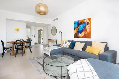 a living room with a couch and a table at Blue Pearl Vue Mer By Avecoeur in Nice