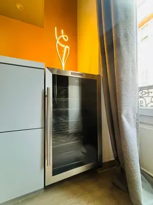 a microwave oven in a room with an orange wall at Bonaparte - Nice in Nice