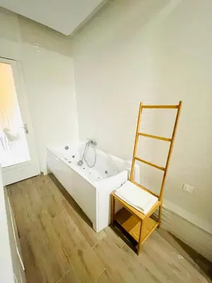 a bathroom with a white tub and a chair at Bonaparte - Nice in Nice