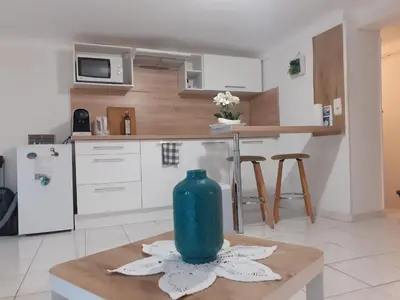 a living room with a bed and a table with a table at Studio neuf centre ville Quartier Libération in Nice