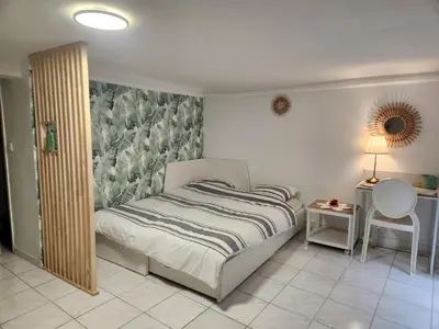 a living room with a couch and a tv at Studio neuf centre ville Quartier Libération in Nice