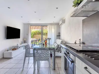 a kitchen with a table and a dining room at Apartment Le Marbeau-2 by Interhome in Cagnes-sur-Mer