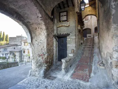 an old building with a door in a street at Apartment Le Marbeau-2 by Interhome in Cagnes-sur-Mer
