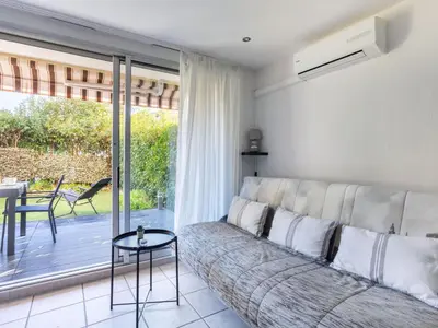 a living room with a couch and a table at Apartment Le Marbeau-2 by Interhome in Cagnes-sur-Mer