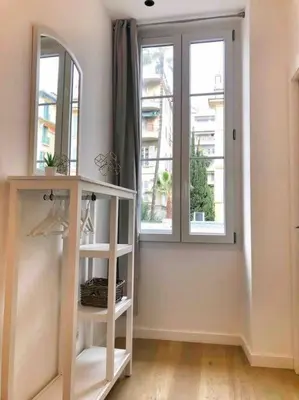 a room with two windows and a white shelf at Homelivia, Votre Appartement ideal pour découvrir Nice in Nice