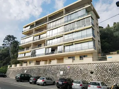a large building with cars parked in front of it at Vintage flat on Villefranche bay - free car park in Villefranche-sur-Mer