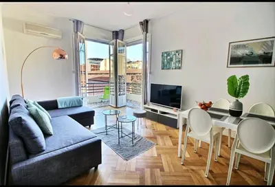 a living room with a couch and a table at Central, climatisé, proche Promenade des anglais. in Nice